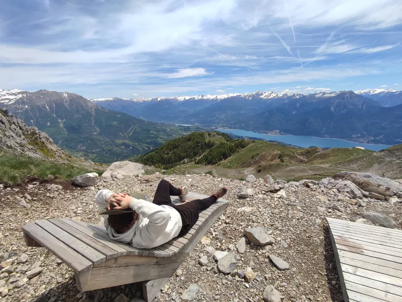 Banc face au lac, sommets encore enneigés à l’horizon